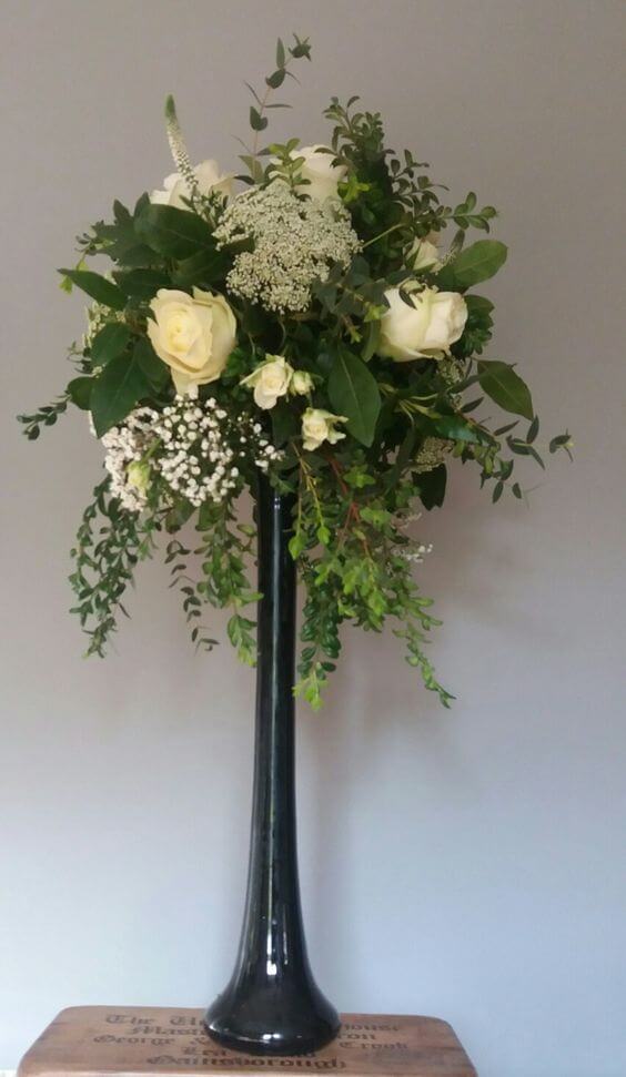 Tall vase with cream flowers